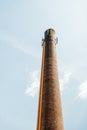 Chimney brick smoke stack with mobile phone antenna on top Royalty Free Stock Photo