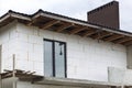 Chimney of bricks on house roof under construction Royalty Free Stock Photo