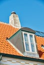 Chimney chute, window and sunroof skylight designed on house building outside against blue sky background. Construction Royalty Free Stock Photo