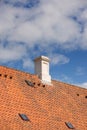 Chimney designed on slate roof of house building outside against blue sky with white clouds background. Construction of Royalty Free Stock Photo