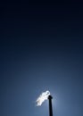 Chimney exhausting steam in blue sky Royalty Free Stock Photo