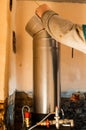 Chimney for the fireplace, installation of a pipe over the fireplace to the chimney, repair work in the house Royalty Free Stock Photo