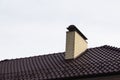 Chimney pipe of brick on the roof of the house Royalty Free Stock Photo