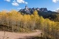 Chimney Rock and Court House Mountain stands above an aspen grove along Owl Creek Pass road. Royalty Free Stock Photo