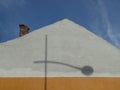 Chimney on the roof of a house with street lamp shadow on the wall Royalty Free Stock Photo