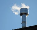 Chimney on the roof with smoke coming out from the boiler Royalty Free Stock Photo