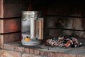 Chimney Starter with fire making more embers inside the barbecue, with glowing charcoal embers Royalty Free Stock Photo