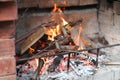 The chimney on the street of red brick is a fire, you can see the wood and branches of trees Royalty Free Stock Photo