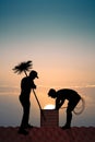 Chimney sweep on the roof at sunset