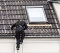 Chimney sweeper climbing the roof Royalty Free Stock Photo