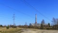 Chimney of thermal power station and electric wires on classic blue sky background. Green power and ecological problem Royalty Free Stock Photo