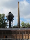 Chimney and water tower behind a train storage Royalty Free Stock Photo