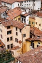 Chimneys on the red tiled roofs of old houses. Bergamo, Italy Royalty Free Stock Photo