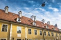 Chimneys and red-tiled roofs of the old yellow building in Old R Royalty Free Stock Photo