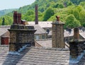 Chimneys and roofs of traditional stone built houses and mills typical of yorkshire small towns and villages Royalty Free Stock Photo