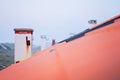 Chimneys in a Row on Red Clay Tiles Rooftop Royalty Free Stock Photo