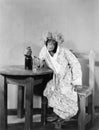 Chimpanzee dressed as woman with bottle and shot glass