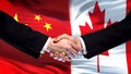 China and Canada handshake, international friendship relations, flag background
