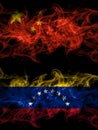 China, Chinese vs Venezuela smoky mystic flags placed side by side. Thick colored silky abstract smoke flags