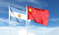 China flag and Argentina flag on cloudy sky. Royalty Free Stock Photo