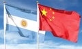 China flag and Argentina flag on cloudy sky Royalty Free Stock Photo
