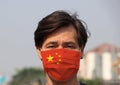 China flag on hygienic mask. Masked Asian man prevent germs. concept of virus corona protection Royalty Free Stock Photo