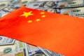 China flag with US dollars as background. Concept for investors, soft focus