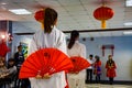 Girls dancing with red fans in celebration of the Chinese New Year Royalty Free Stock Photo