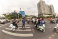 China, Hainan Island, Dadonghai Bay City street, Chinese city traffic on motorbikes at a crossroads