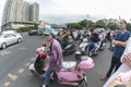 China, Hainan Island, Dadonghai Bay: City street, Chinese city traffic on motorbikes at a crossroads