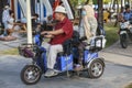 China, Hainan Island, Sanya bay - City street, Chinese electric moped tricycle, elderly chinese couple on a Royalty Free Stock Photo