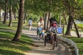 China, Hainan Island, Sanya bay - City street, Chinese electric moped tricycle, elderly chinese couple on a Royalty Free Stock Photo