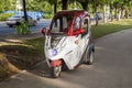 China, Hainan Island, Sanya bay -: City street, Chinese tricycle electric moped, Chinese woman on an electric Royalty Free Stock Photo