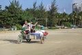 China, Hainan Island, Sanya bay - Sanya bay , Chinese tricycle electric moped, Chinese people on an electric Royalty Free Stock Photo