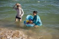 China, Hainan Island - Yalong Bay, the best beach in Hainan Island, a large Chinese family bathes a child for