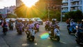 China, Hainan, Sanya - May 13, 2019: Road traffic on the background of the setting sun