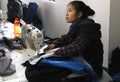 CHINA - JANUARY 15: Young seamstress in Chinese clothes factory