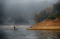 Fishman rowing canoe Royalty Free Stock Photo