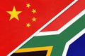 China or PRC vs South Africa national flag from textile. Relationship between Asian and African countries Royalty Free Stock Photo