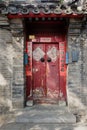 China Red Door with Mandarin writing in old hutong in Beijing, China. Writing on door mean good wishes as Lunar New Year