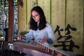 CHINA, SHANGHAI - NOVEMBER 7, 2017: Chinese girl is playing Guzheng or zheng. Chinese plucked zither a traditional Royalty Free Stock Photo