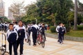 China students riding a bike after school