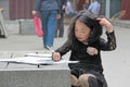 China, Suzhou - April 14, 2012. A Chinese girl draws in a book o