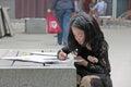 China, Suzhou - April 14, 2012. A Chinese girl draws in a book or paints pictures