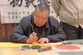 China, Suzhou - April 14, 2012. A man writes calligraphy in Chin