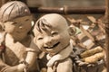 China,Suzhou-18 AUG 2017: smile face Pottery children boy figure closeup view