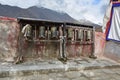 China,Tibet, Lhasa. The ancient monastery Pabongka. Tibetan prayer wheels or prayer`s rolls of the faithful Buddhists Royalty Free Stock Photo