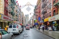 China Town New York City with retail stores and traffic, People walking on the street, rainy winter day