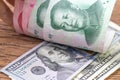 China and USA finance trade war talk or tariff discussion metaphor, US dollar banknotes face up to Chinese Yuan banknotes,