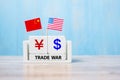 China and USA trade war concept. Chinese yuan and American Dollar symbol with flags Royalty Free Stock Photo